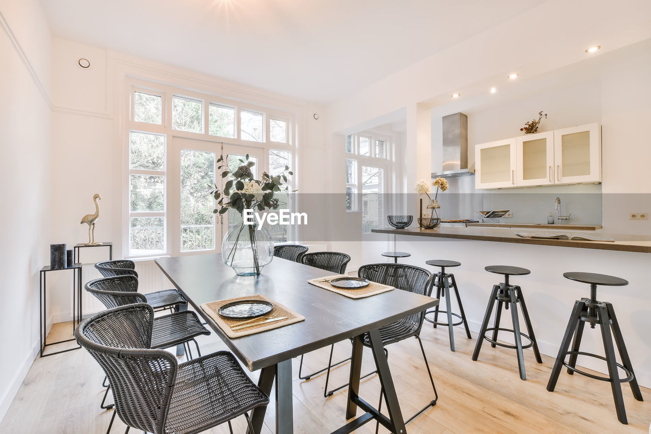 Empty chairs and table at kitchen