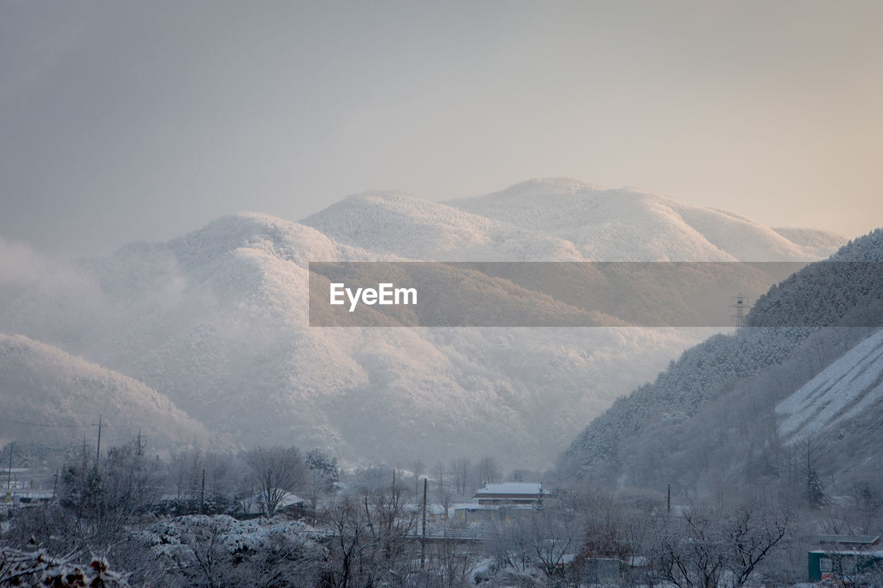 Scenic view of snow covered mountains against sky