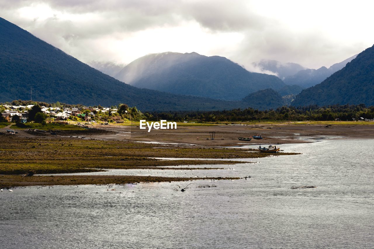 Scenic view of lake and mountains against sky