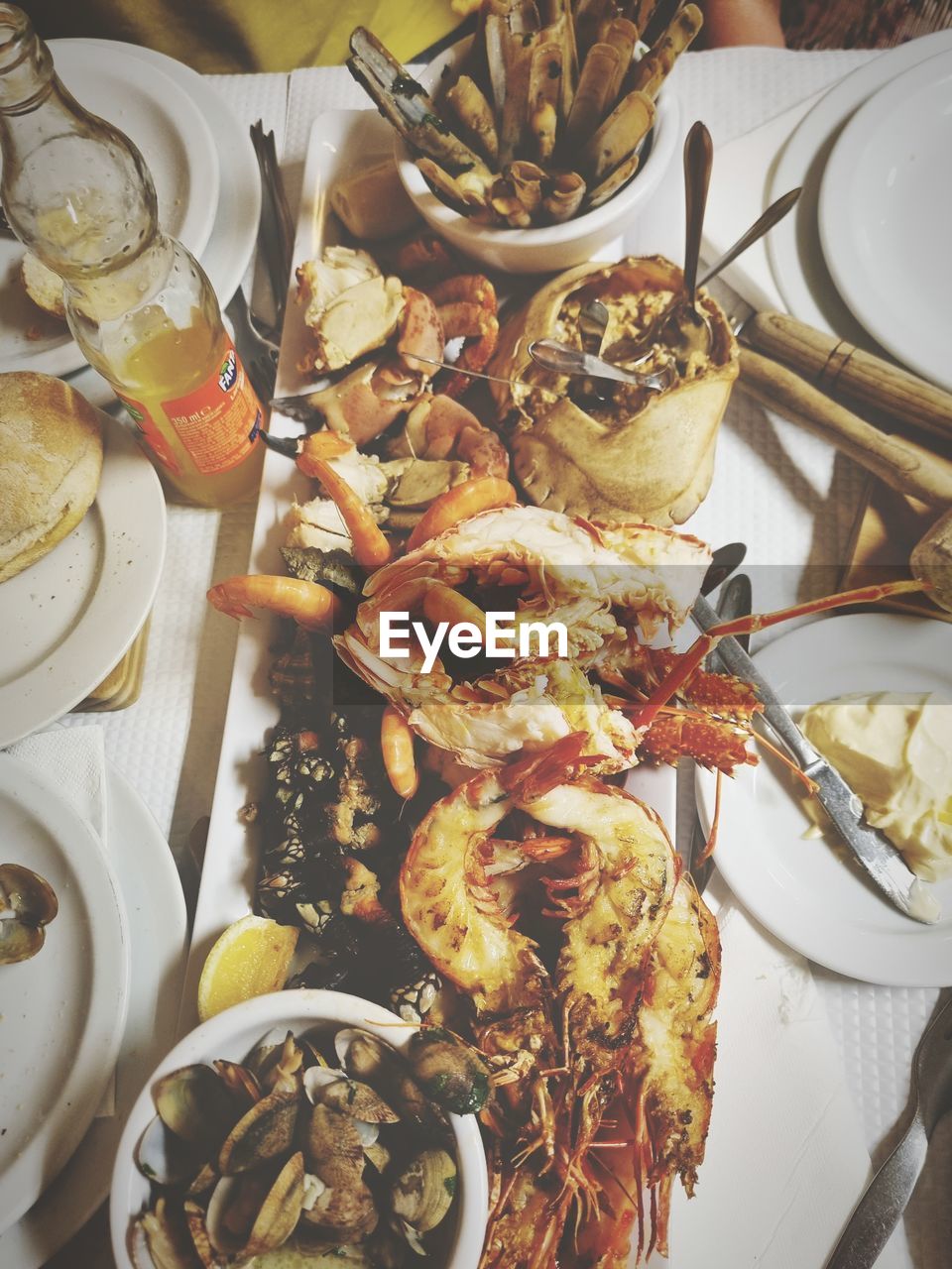 food and drink, food, freshness, meal, table, plate, high angle view, seafood, healthy eating, indoors, wellbeing, crustacean, still life, dish, no people, supper, animal, restaurant, serving size, household equipment, eating utensil, kitchen utensil, brunch, abundance, buffet, dinner