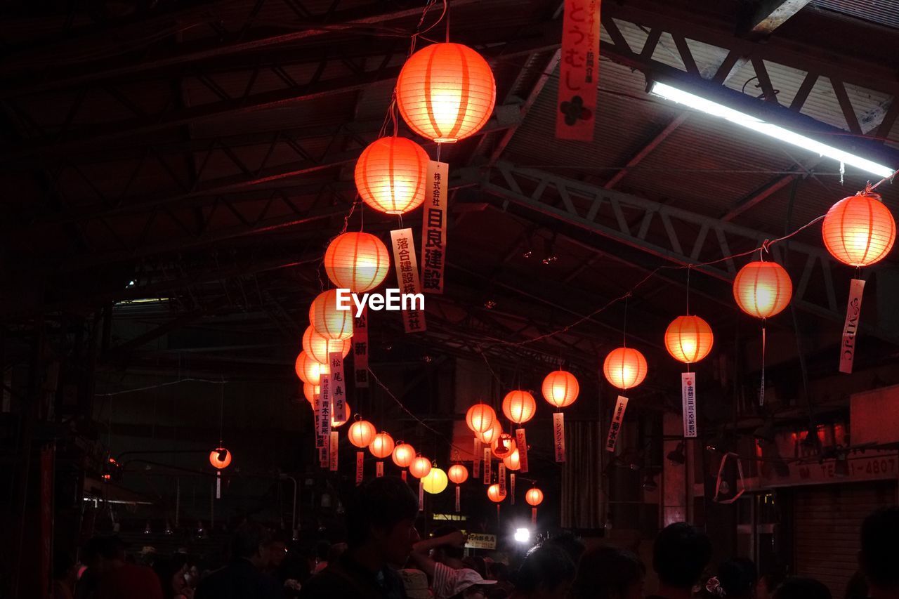 LOW ANGLE VIEW OF LANTERNS HANGING ON LANTERN