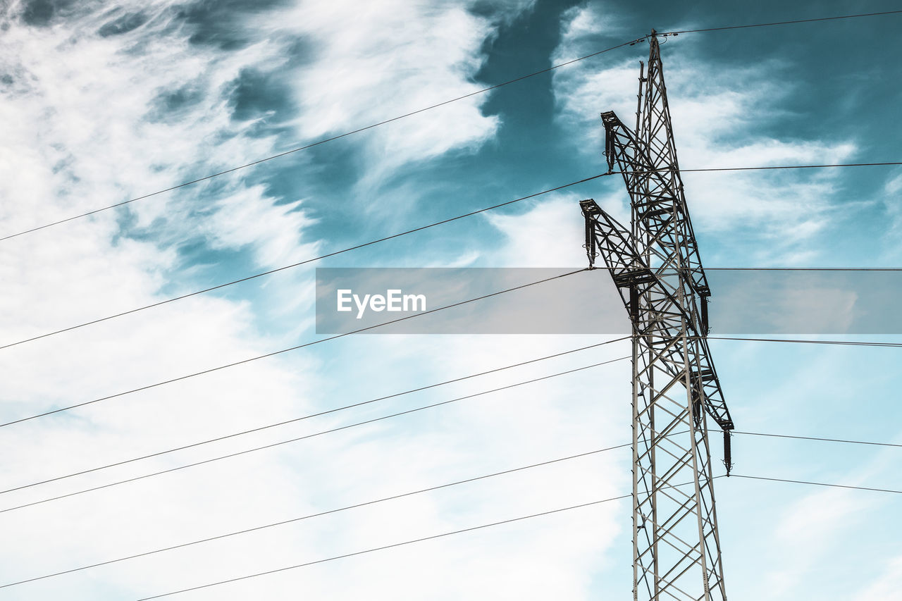 Low angle view of electricity pylon against sky