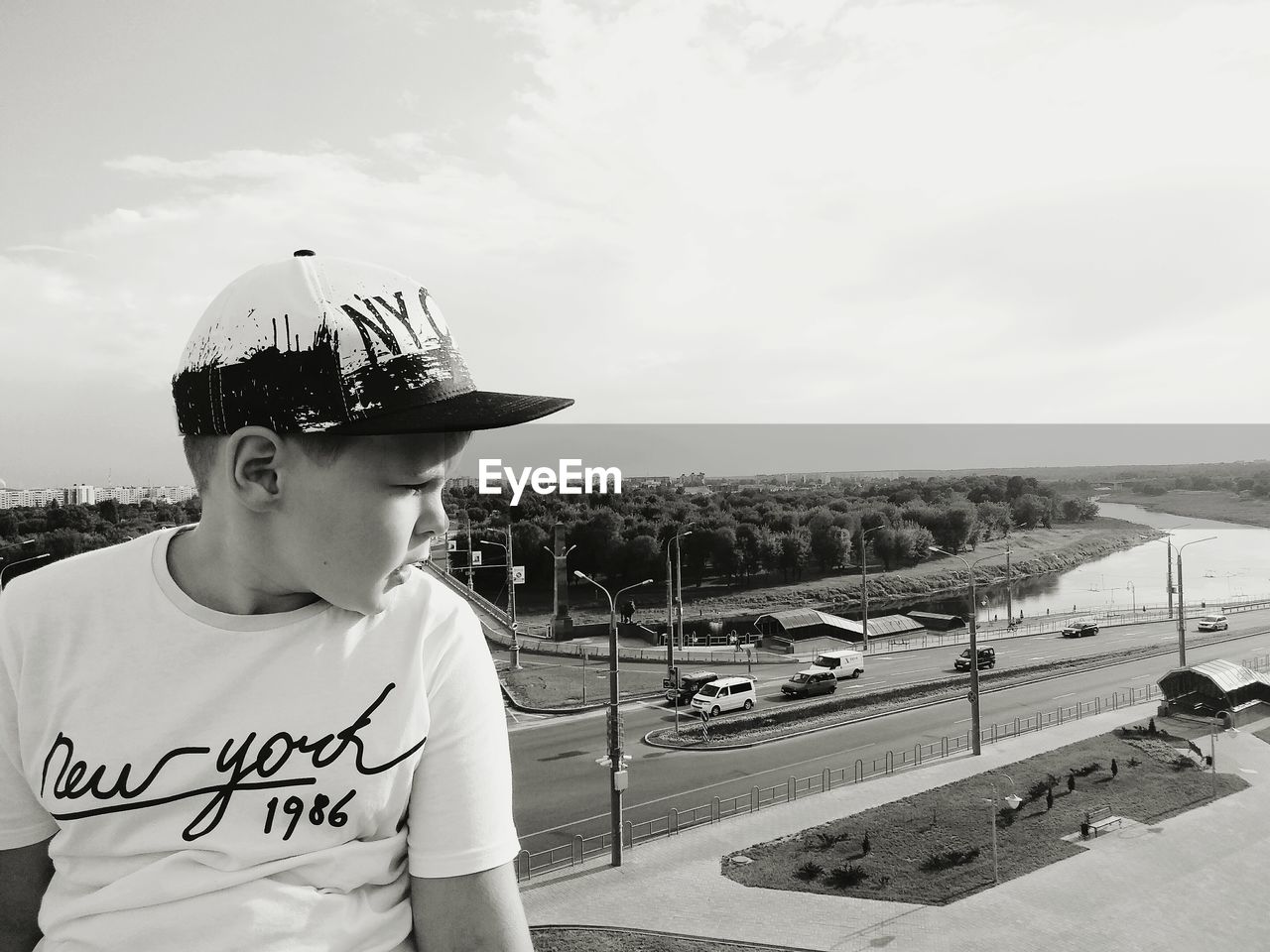 BOY LOOKING AT FARM