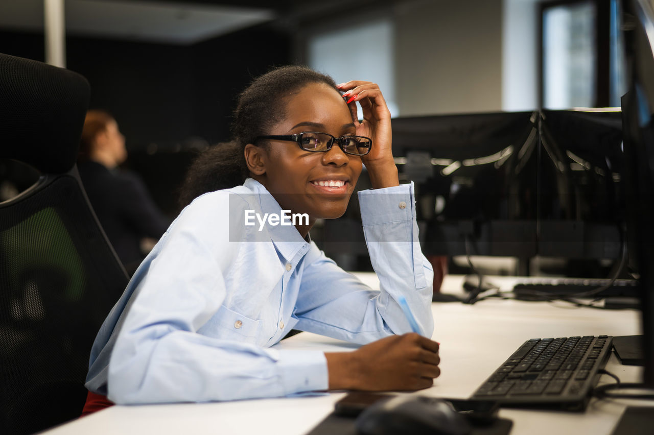 young woman using laptop while sitting at clinic