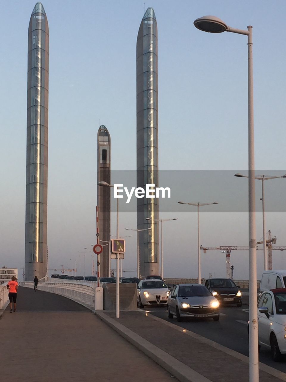 Cars on road in city against clear sky