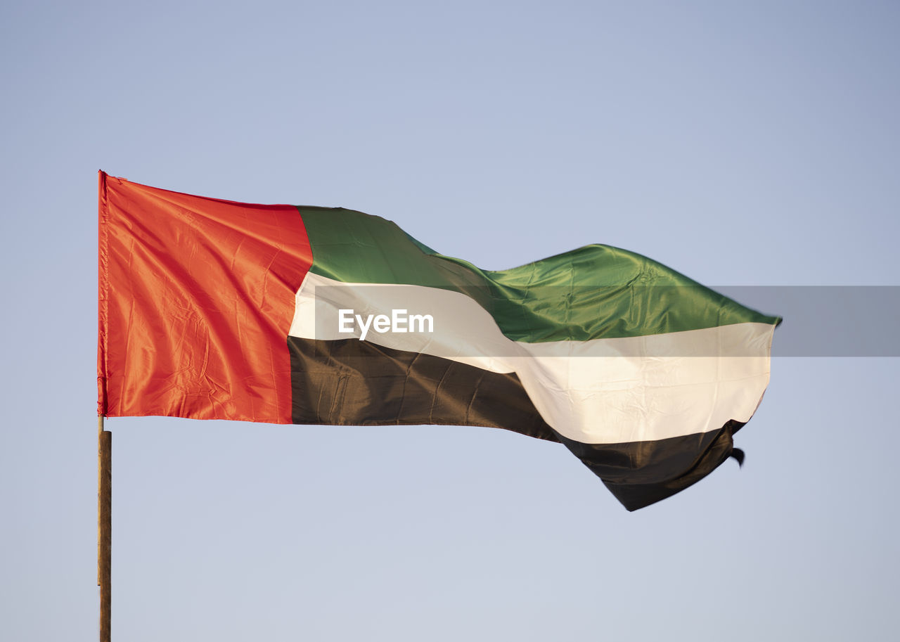 A united arab emirates flag flying proudly in the morning breeze