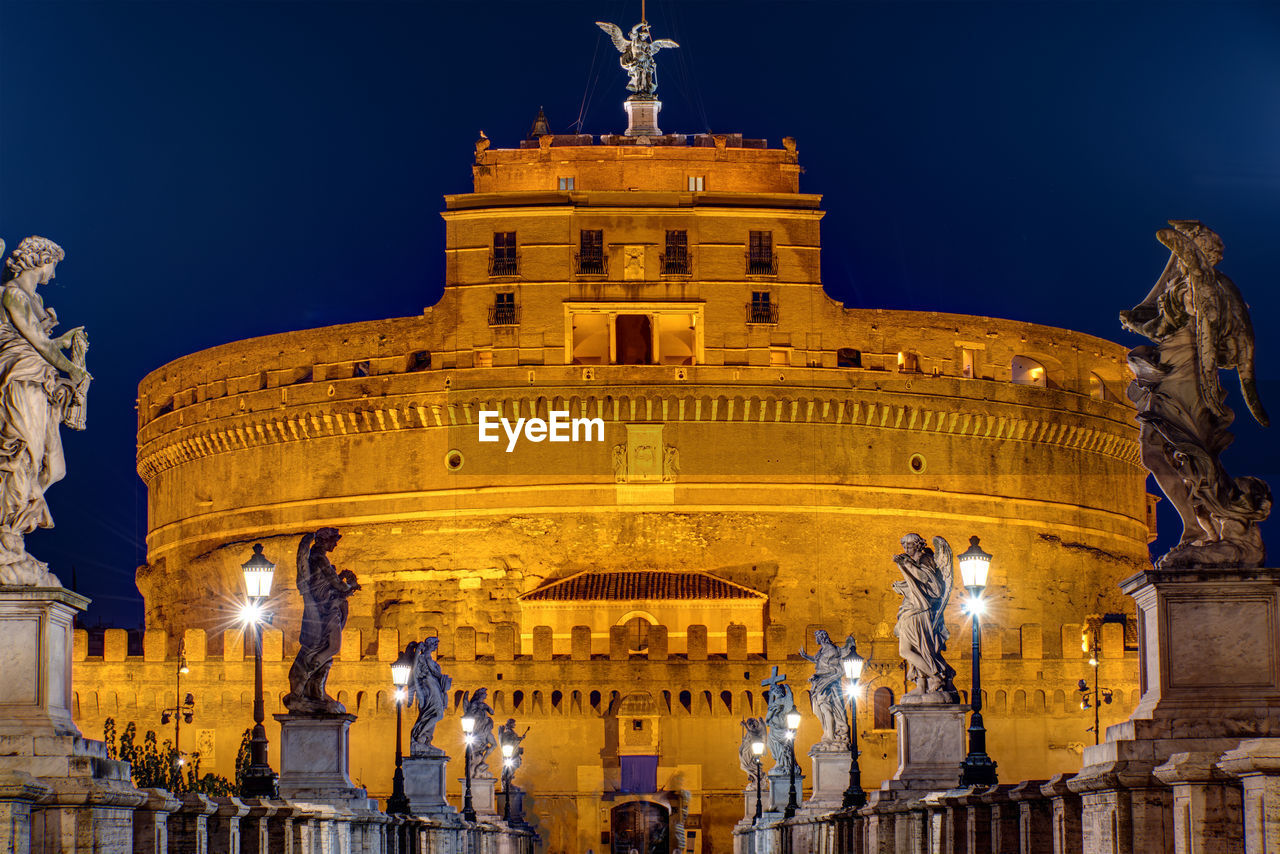 The castel sant angelo and the sant angelo bridge in rome at night