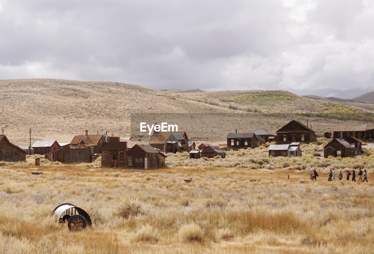 Houses on landscape against sky