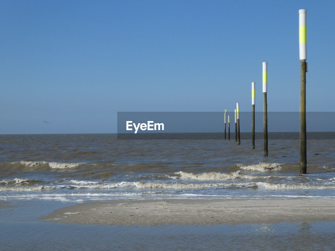 Scenic view of sea against clear blue sky