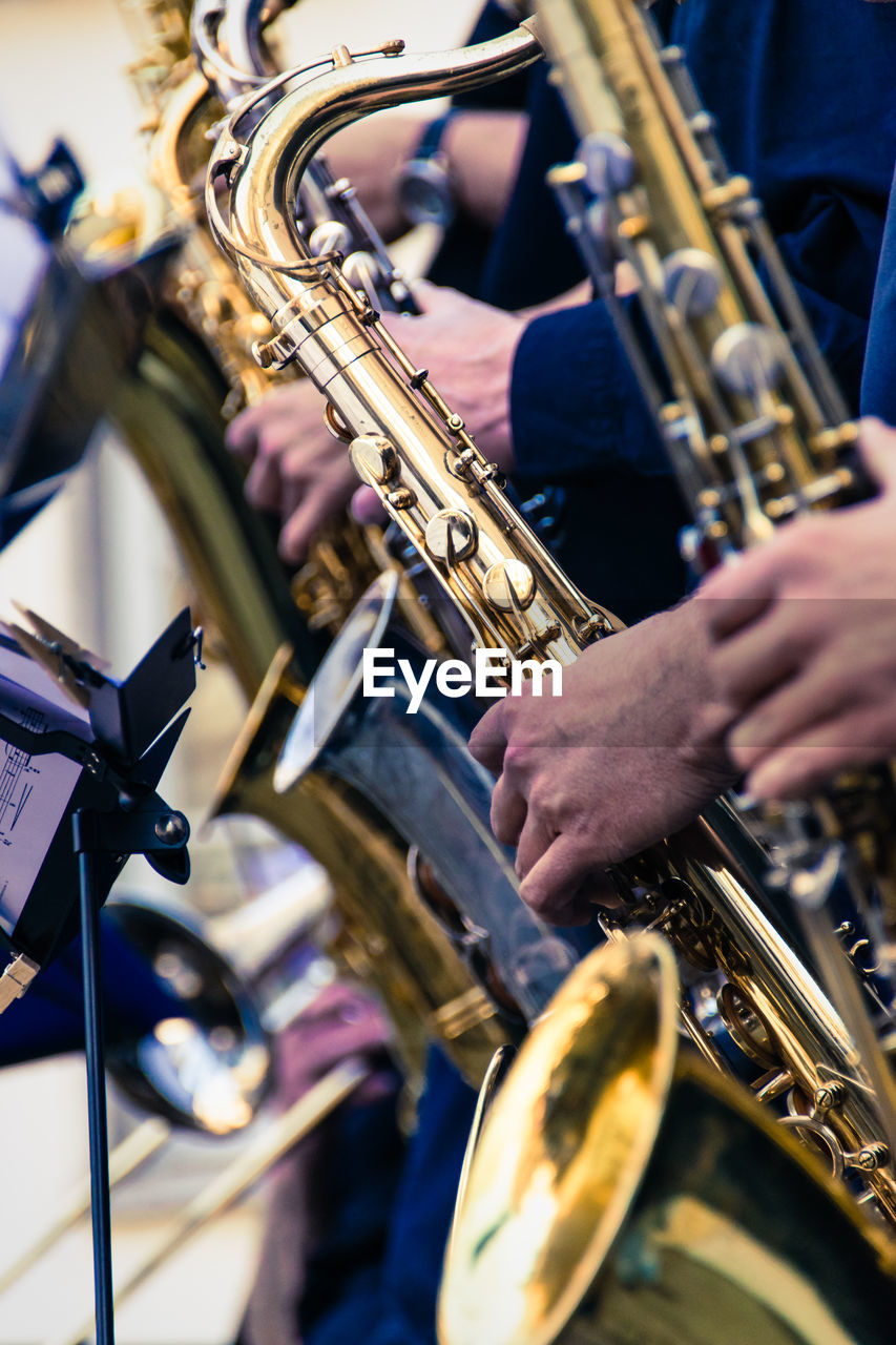 Cropped image of musician playing saxophone during music concert