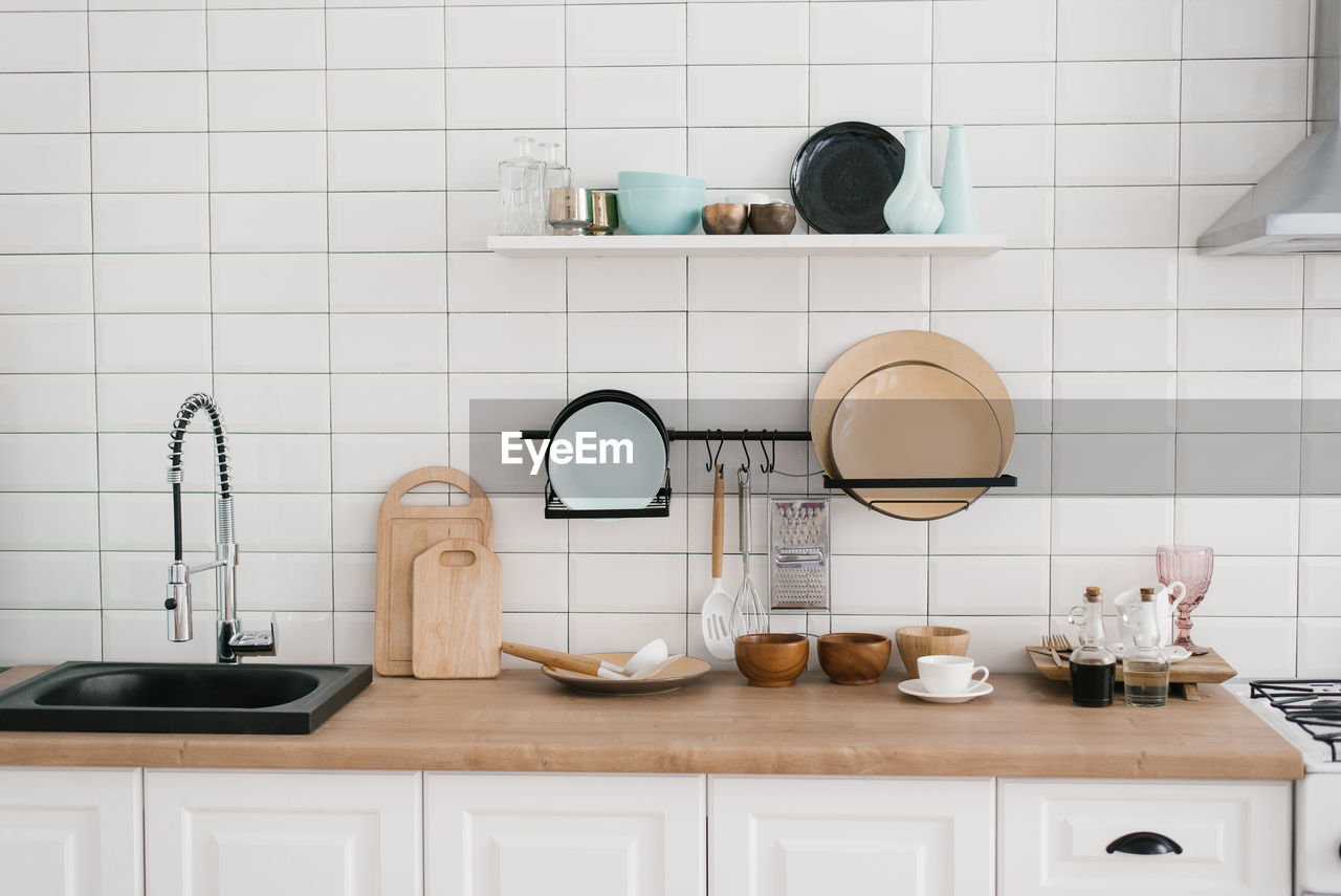 Kitchen utensils and utensils in the bright white wooden kitchen