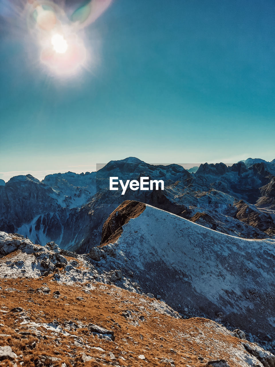 Scenic view of snowcapped mountains against clear sky