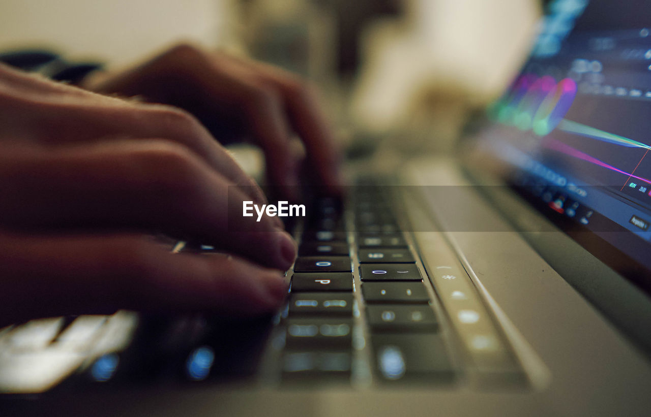 Close up of a hand of a human on a keyboard typing.