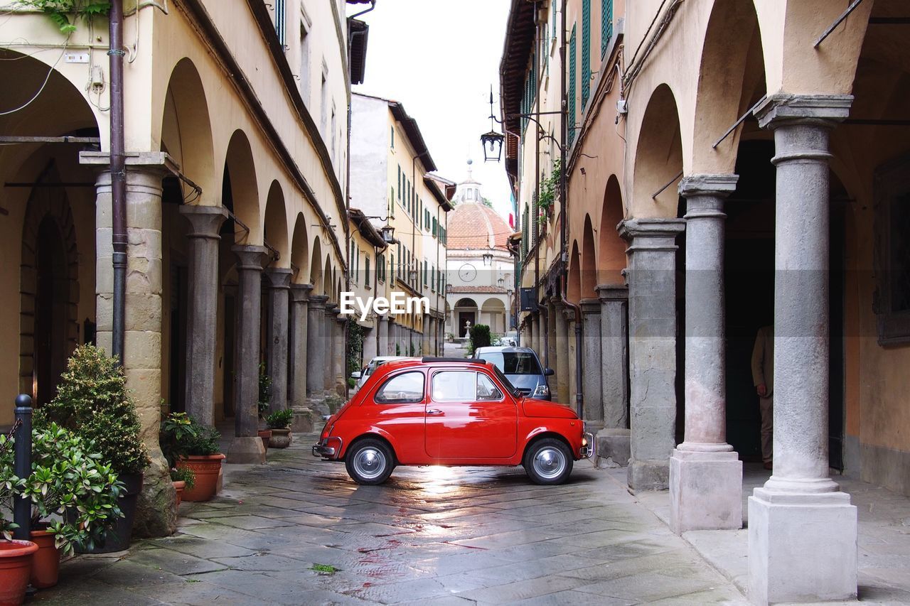 Red beetle car in narrow street