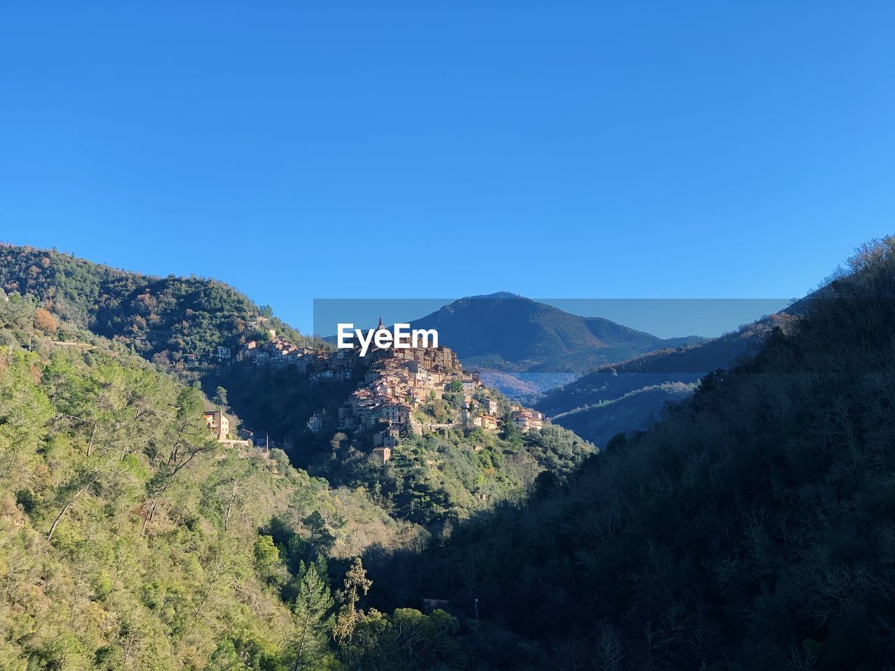 Scenic view of mountains against clear blue sky