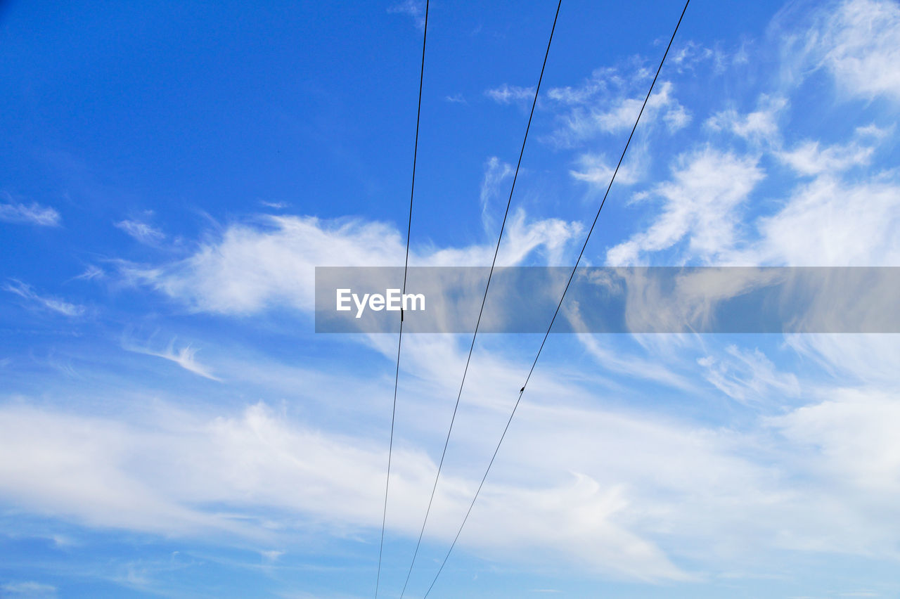 Low angle view of vapor trail against blue sky