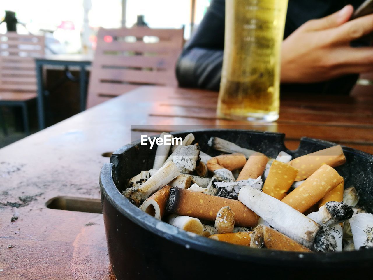 CLOSE-UP OF HAND SMOKING CIGARETTE