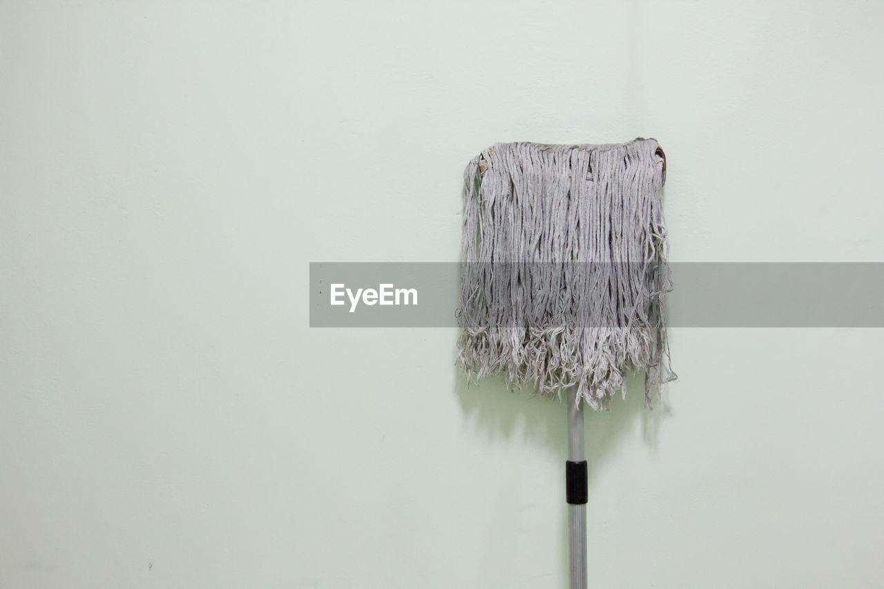 Close-up of mop against wall