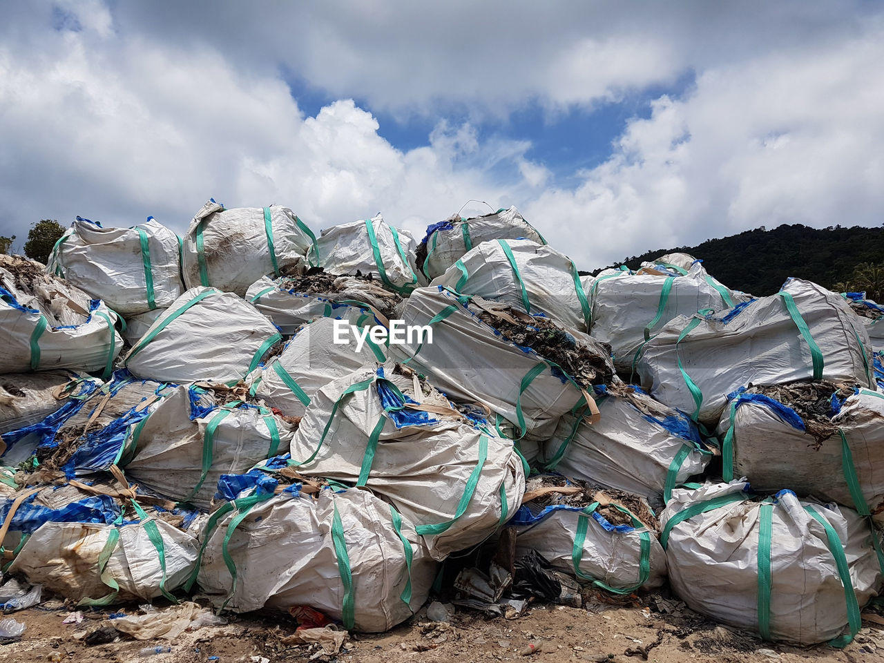 STACK OF GARBAGE AGAINST SKY