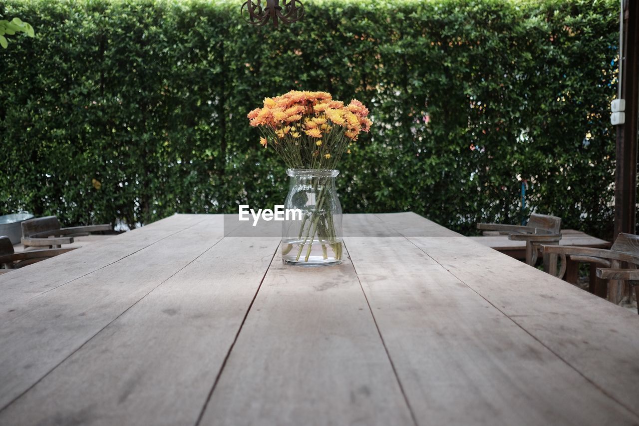 Flowers in jar on table at cafe