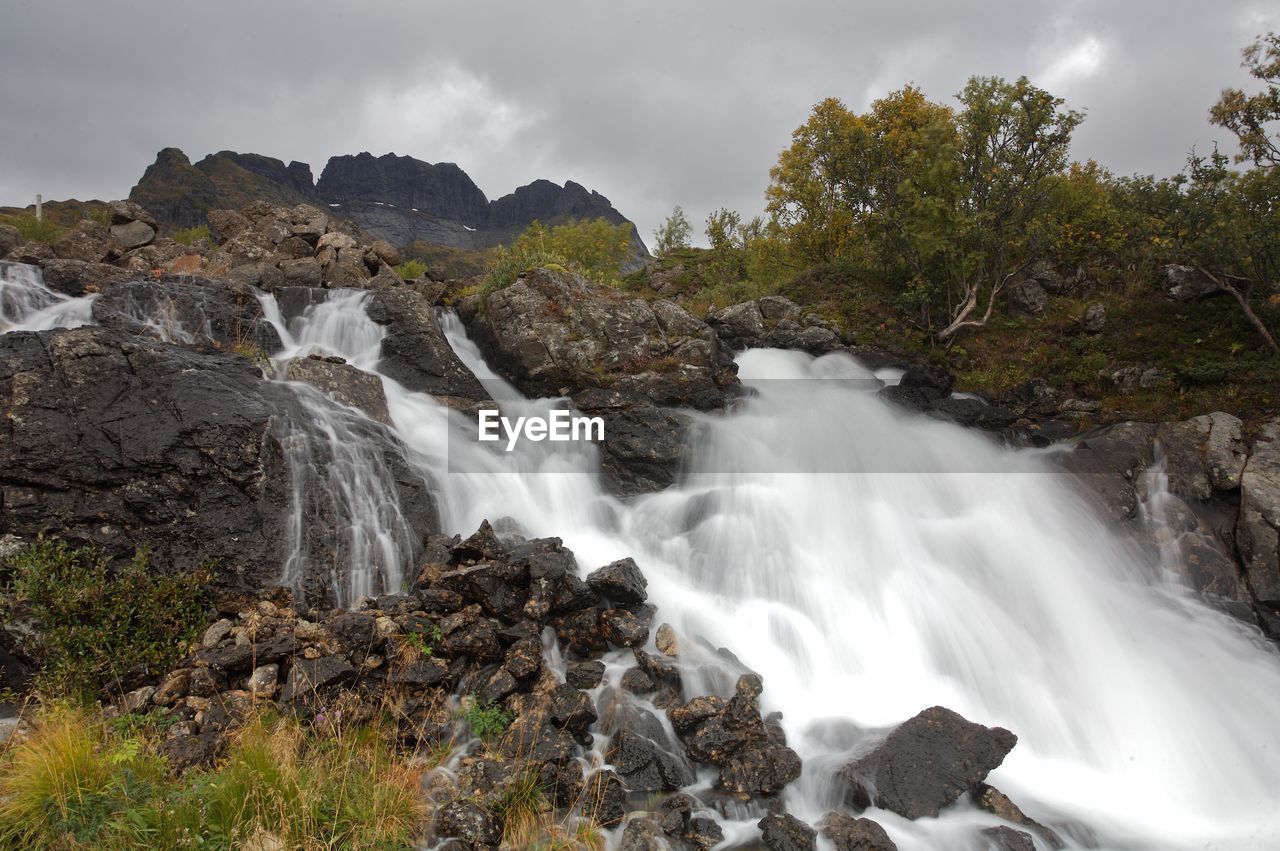 VIEW OF WATERFALL ALONG ROCKS