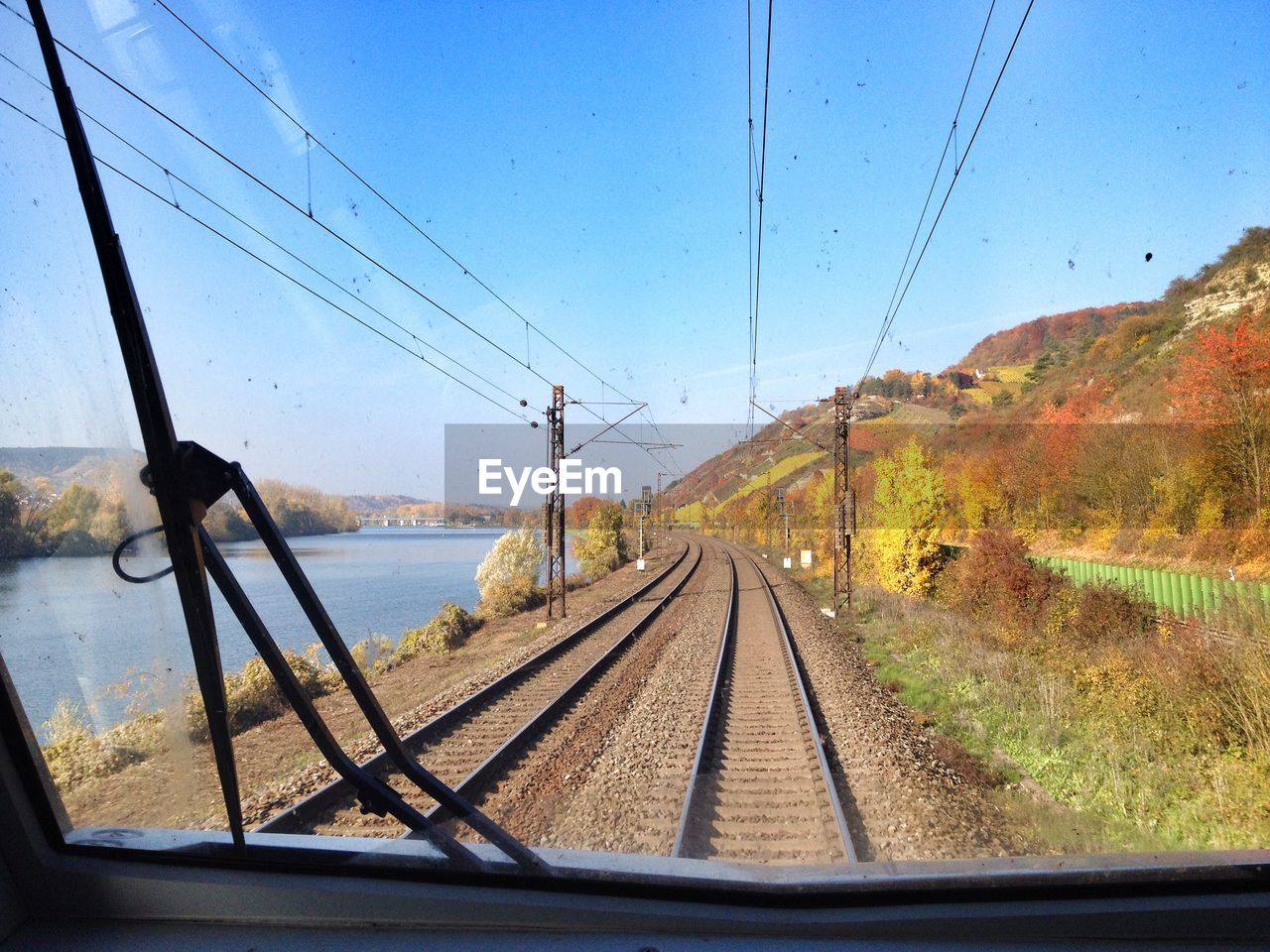 View of railway tracks seen through train windshield