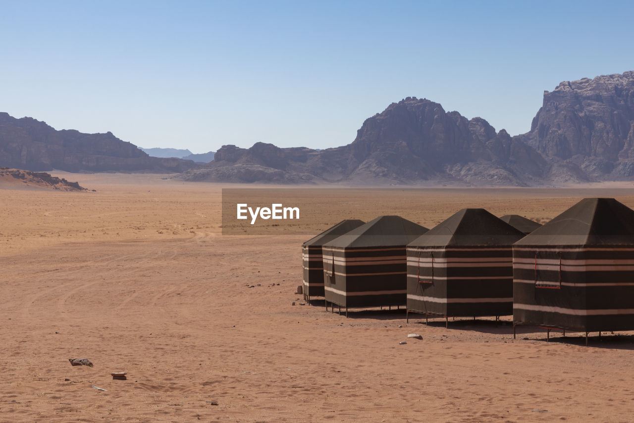 BUILT STRUCTURE ON SAND AGAINST SKY