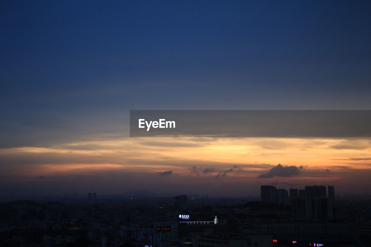 VIEW OF CITYSCAPE AT SUNSET