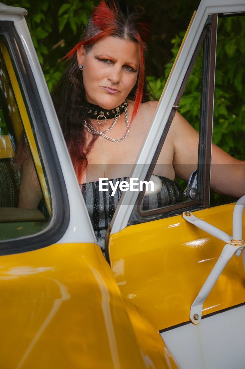 Portrait of smiling woman in car