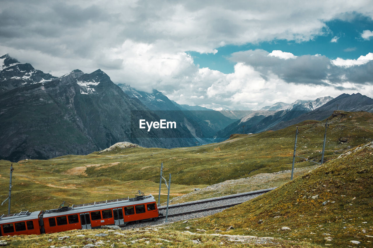 Railway and red train in gornergrat mountains. zermatt, swiss alps. adventure in switzerland.