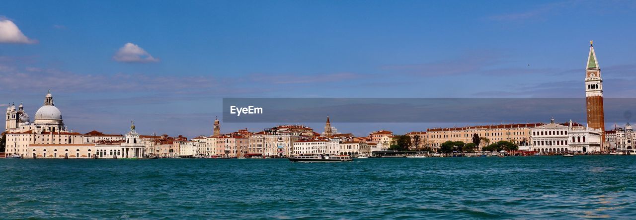 View of buildings by canal against sky in venice 