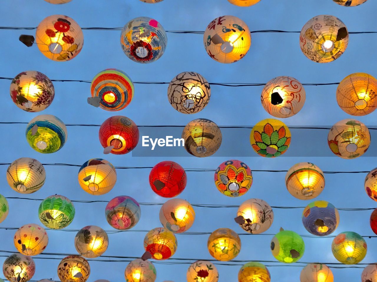 Low angle view of illuminated lanterns hanging on ceiling