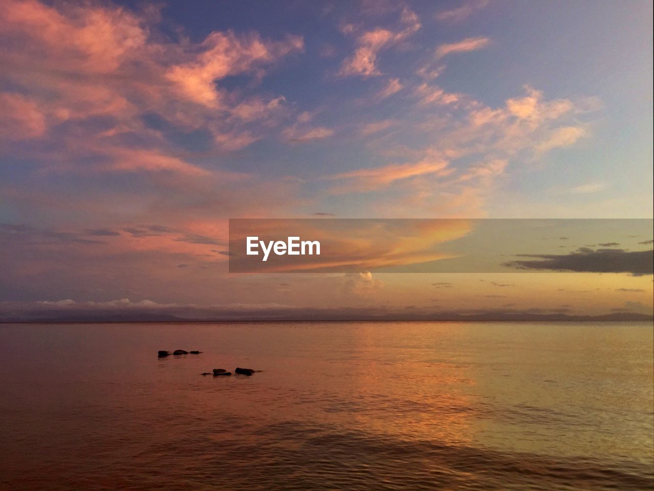 Scenic view of sea against sky at sunset