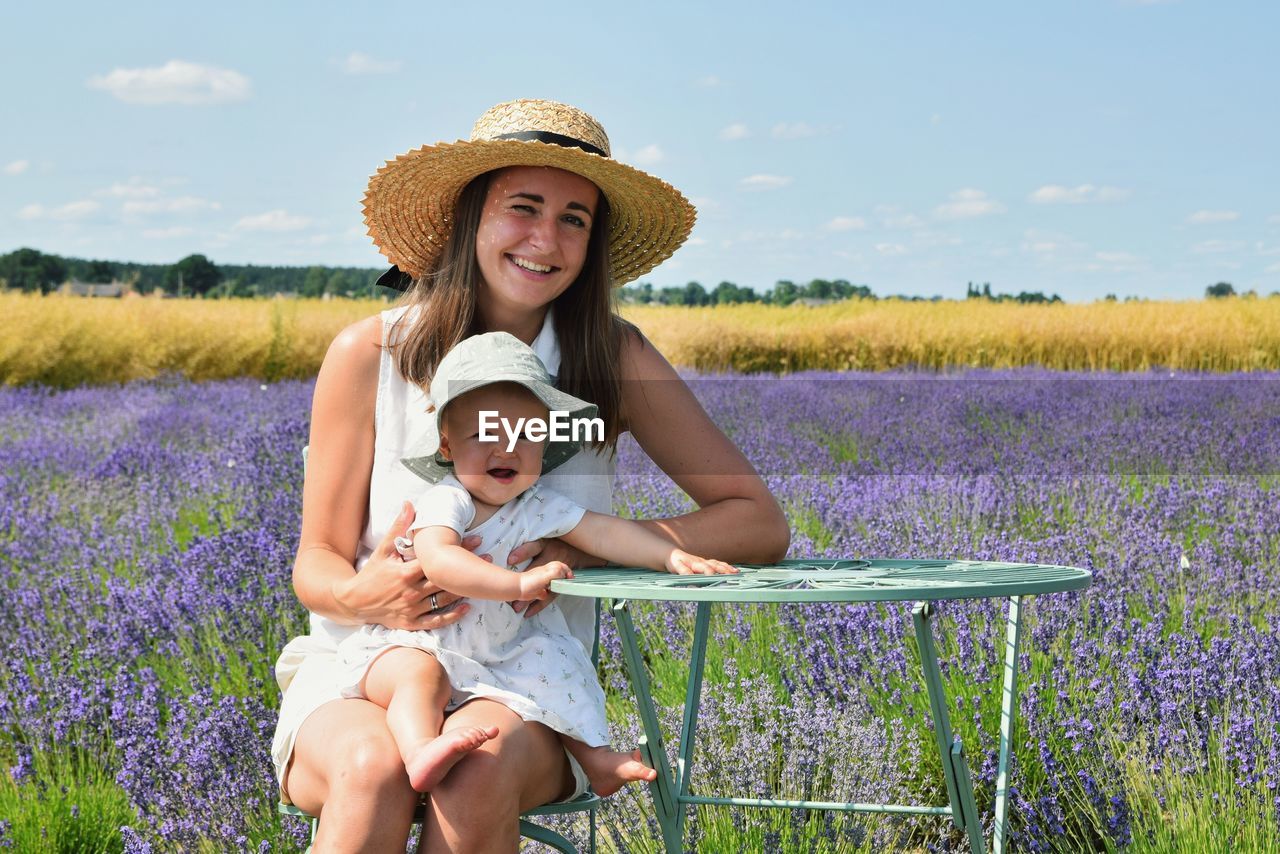 Portrait of a smiling young woman on field