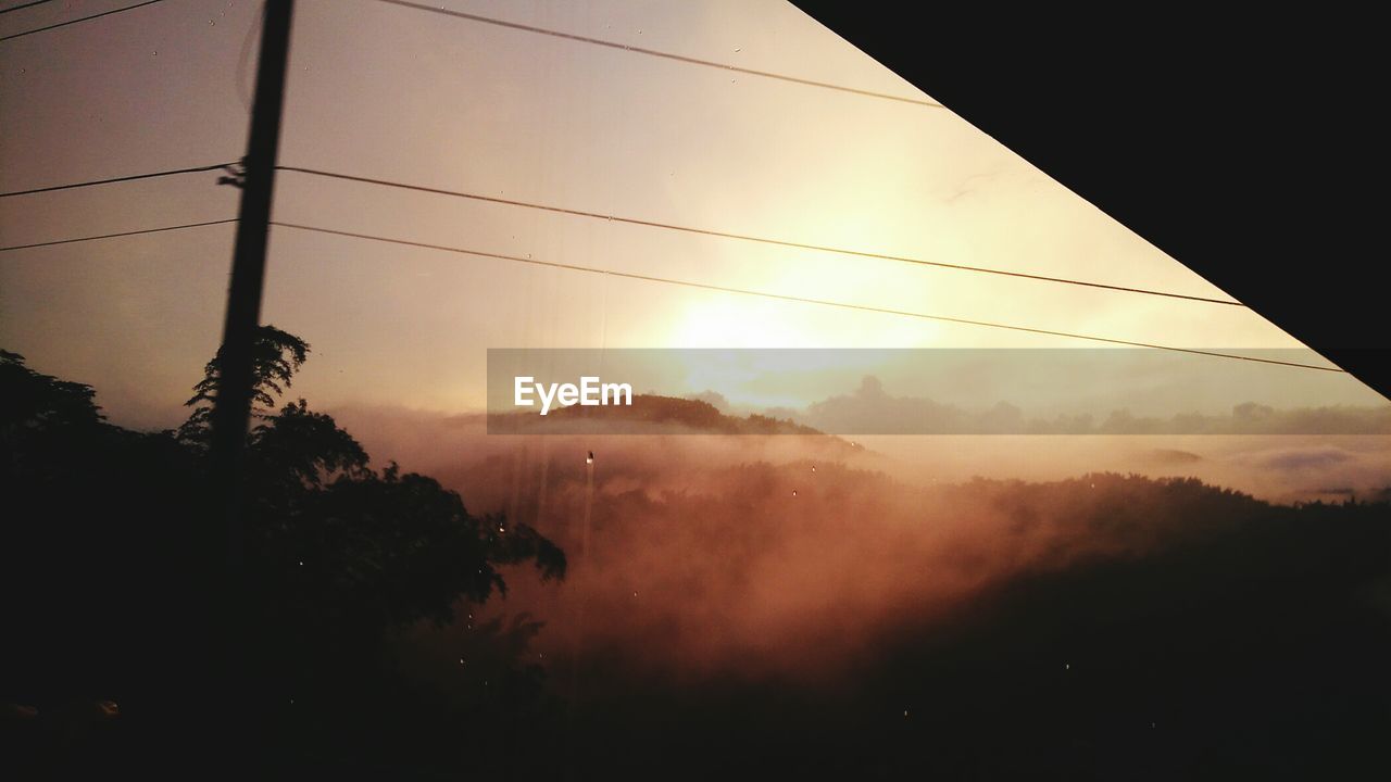 Scenic view of silhouette mountains against sky at sunset