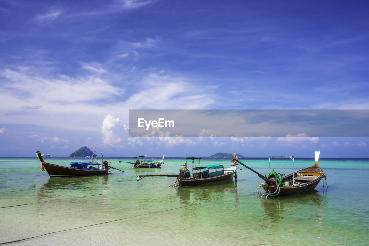 water, nautical vessel, transportation, sea, sky, mode of transportation, cloud, nature, long-tail boat, travel, ocean, scenics - nature, beauty in nature, beach, land, bay, vehicle, shore, travel destinations, blue, boat, vacation, tranquility, no people, coast, outdoors, tranquil scene, ship, moored, horizon, tourism, environment, day, idyllic, tropical climate, watercraft, holiday, horizon over water, wave, lagoon, island, boating, trip