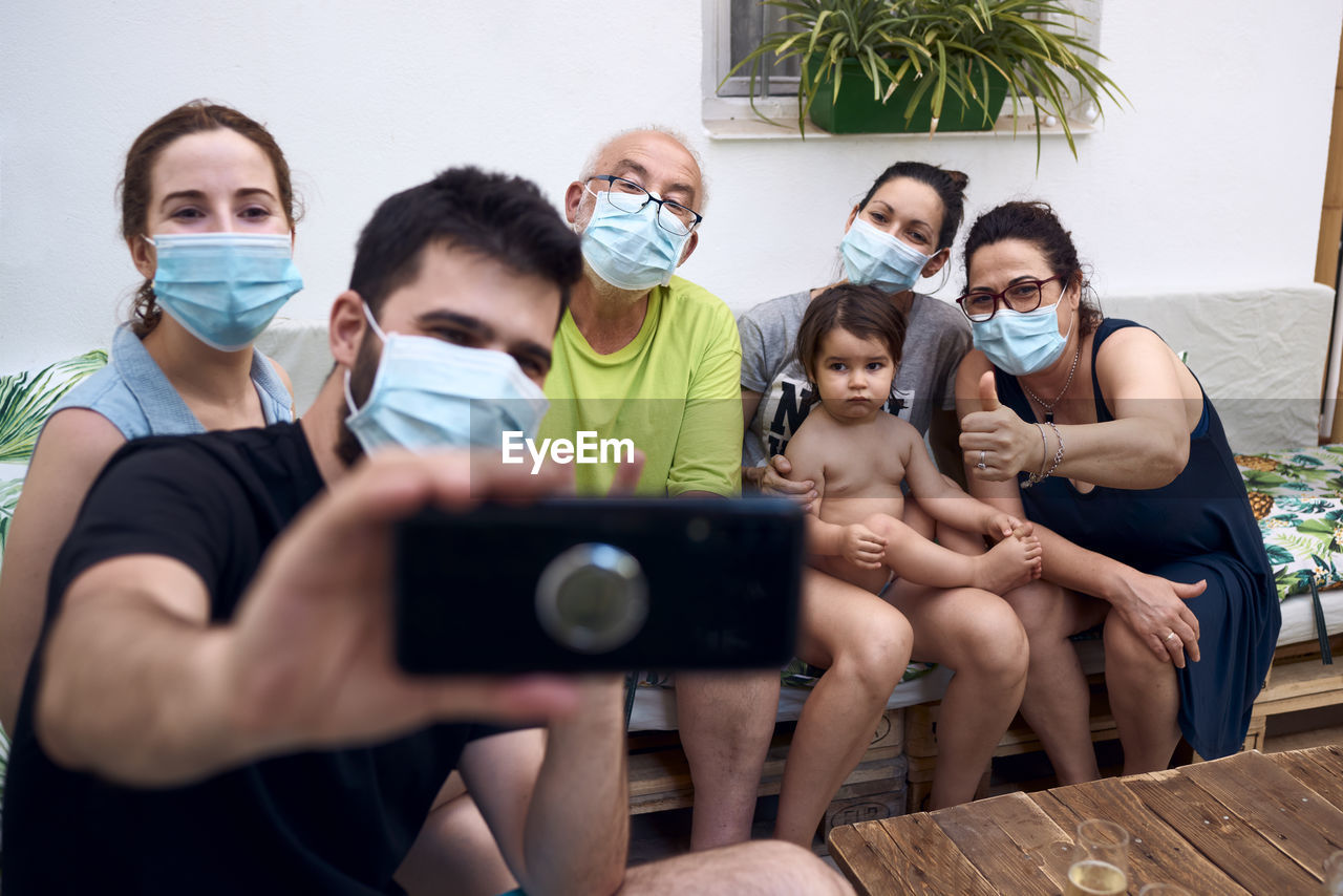 A big family making a selfie with surgical masks. concept family