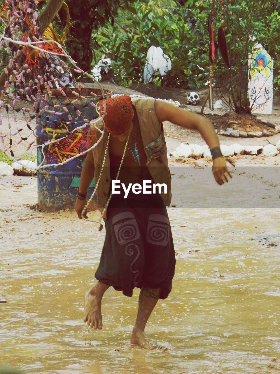 YOUNG WOMAN STANDING IN WATER