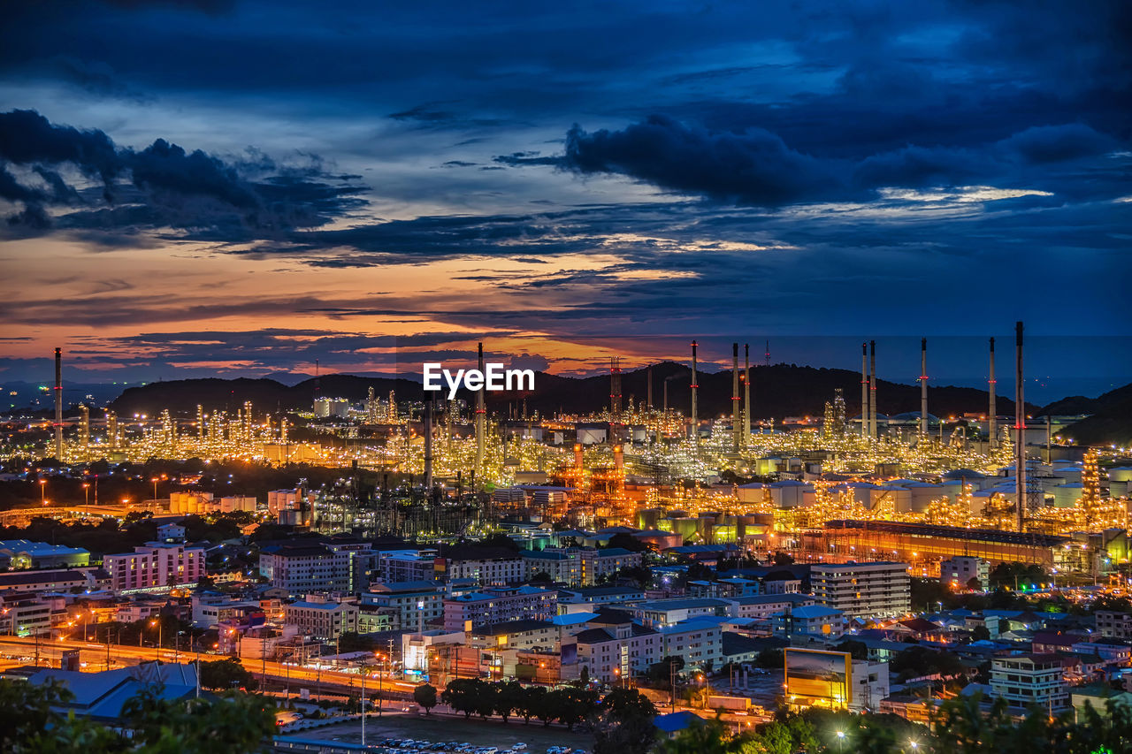 Illuminated cityscape against sky at night