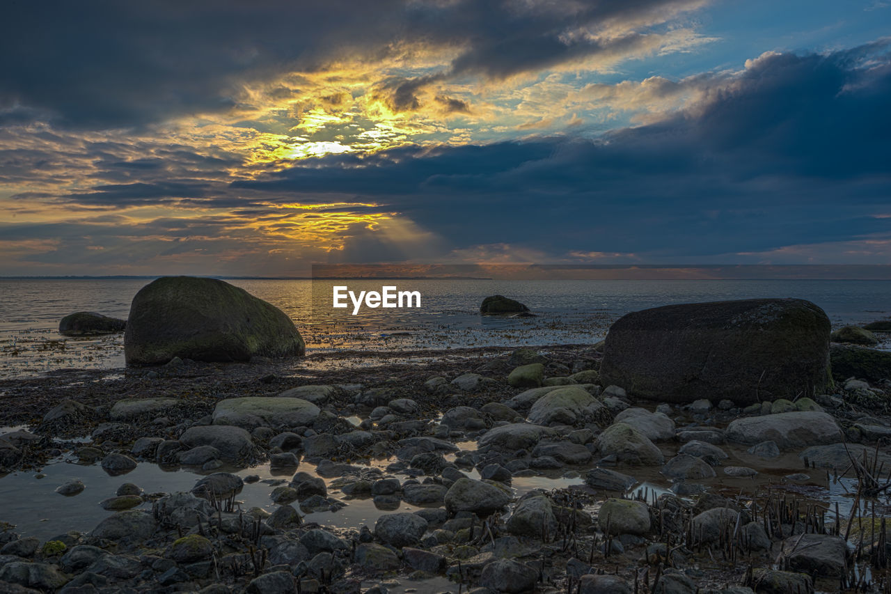 Scenic view of sea against sky at sunset