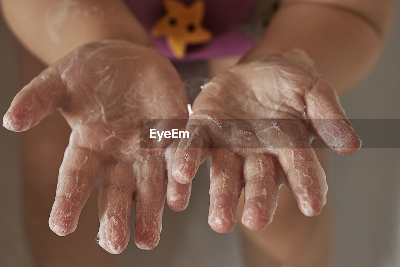 Kid hands in soapy foam. the concept of hand washing, hygiene. pandemic protection. prevention