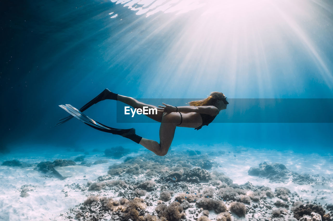 low angle view of woman swimming in sea