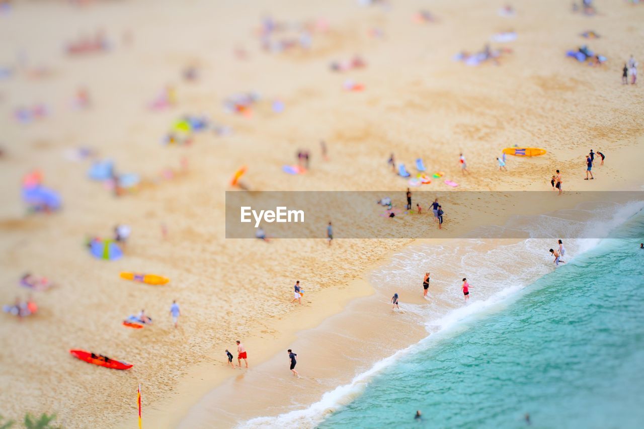 Tilt-shift image of people at beach