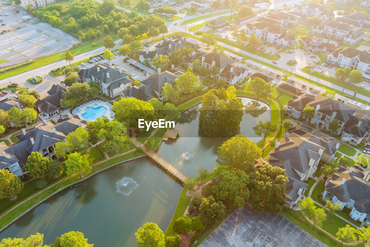 HIGH ANGLE VIEW OF PLANTS BY TREES IN CITY