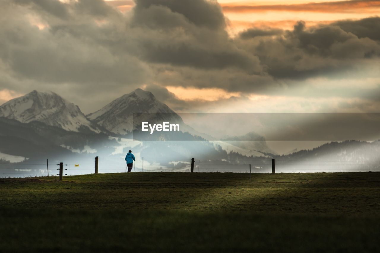 Scenic view of field against snowcapped mountains