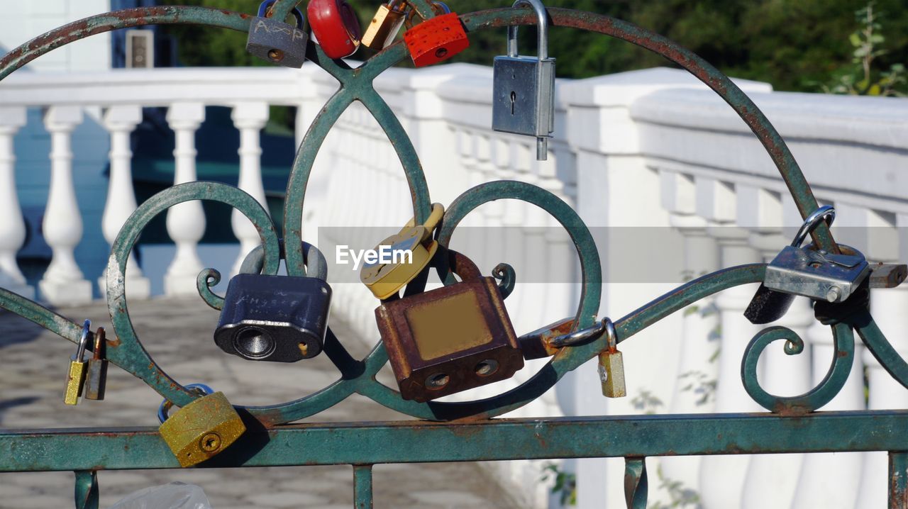 Close-up of love locks hanging on gate