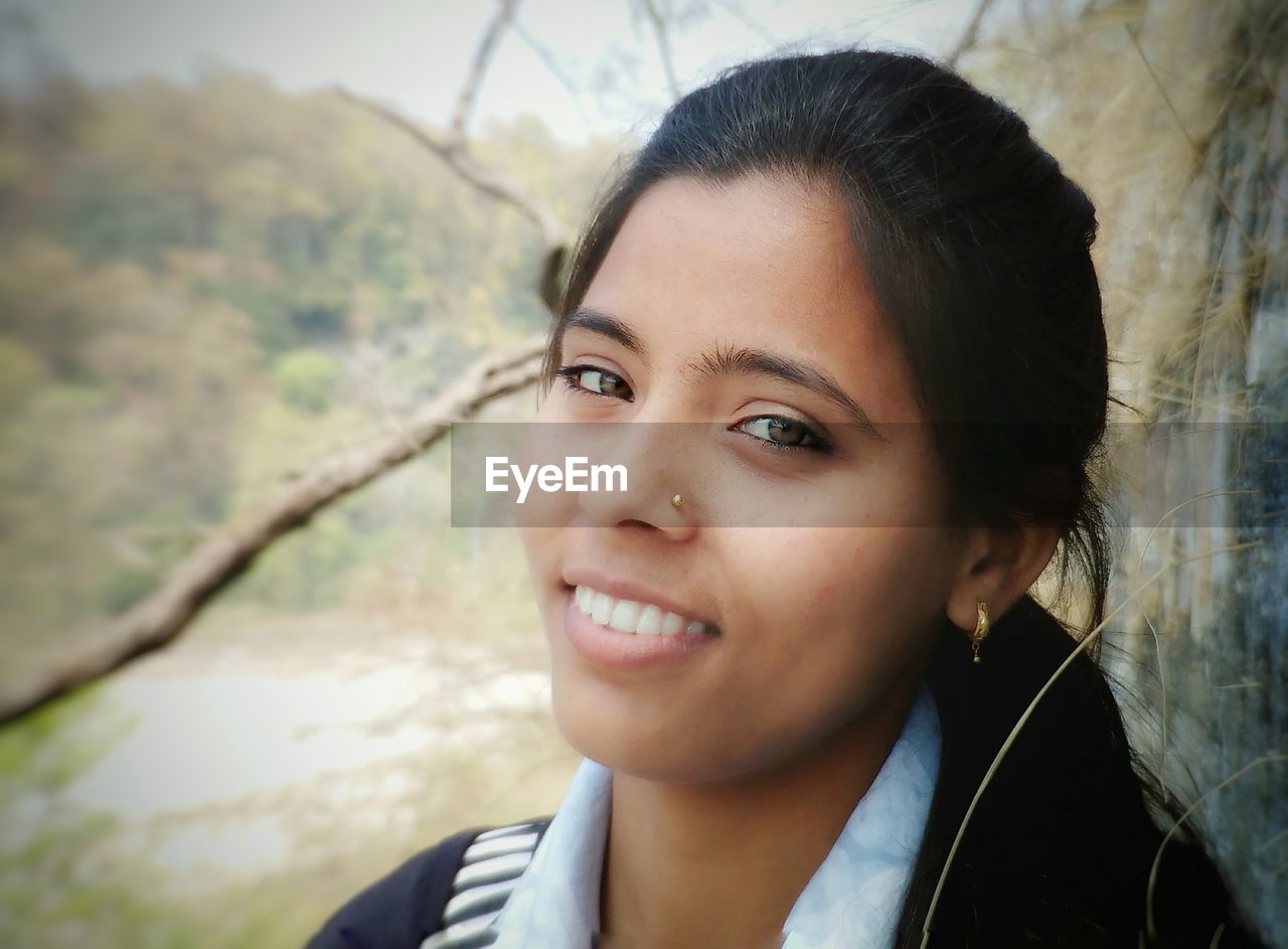 Close-up portrait of smiling young woman