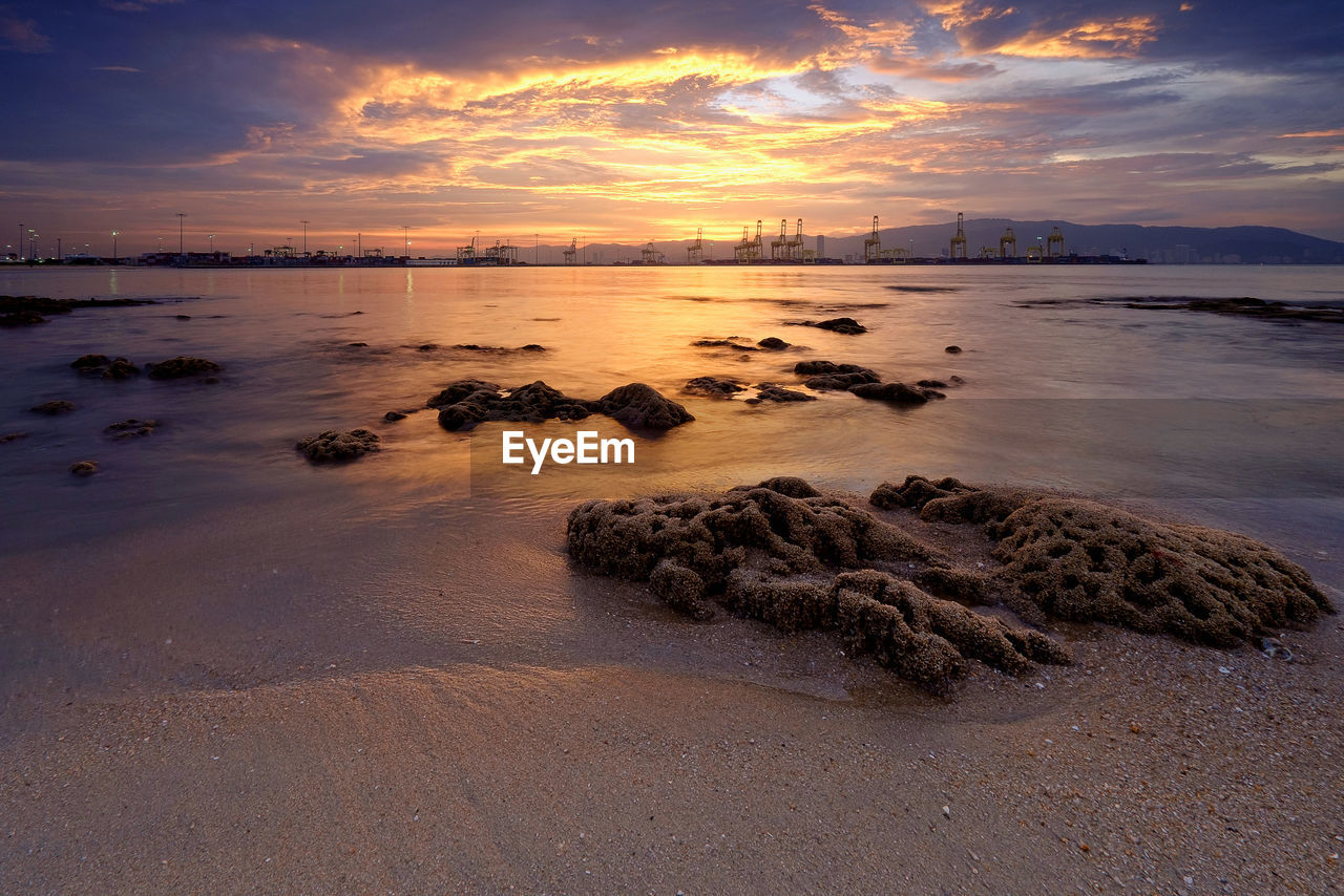 Scenic view of sea against cloudy sky