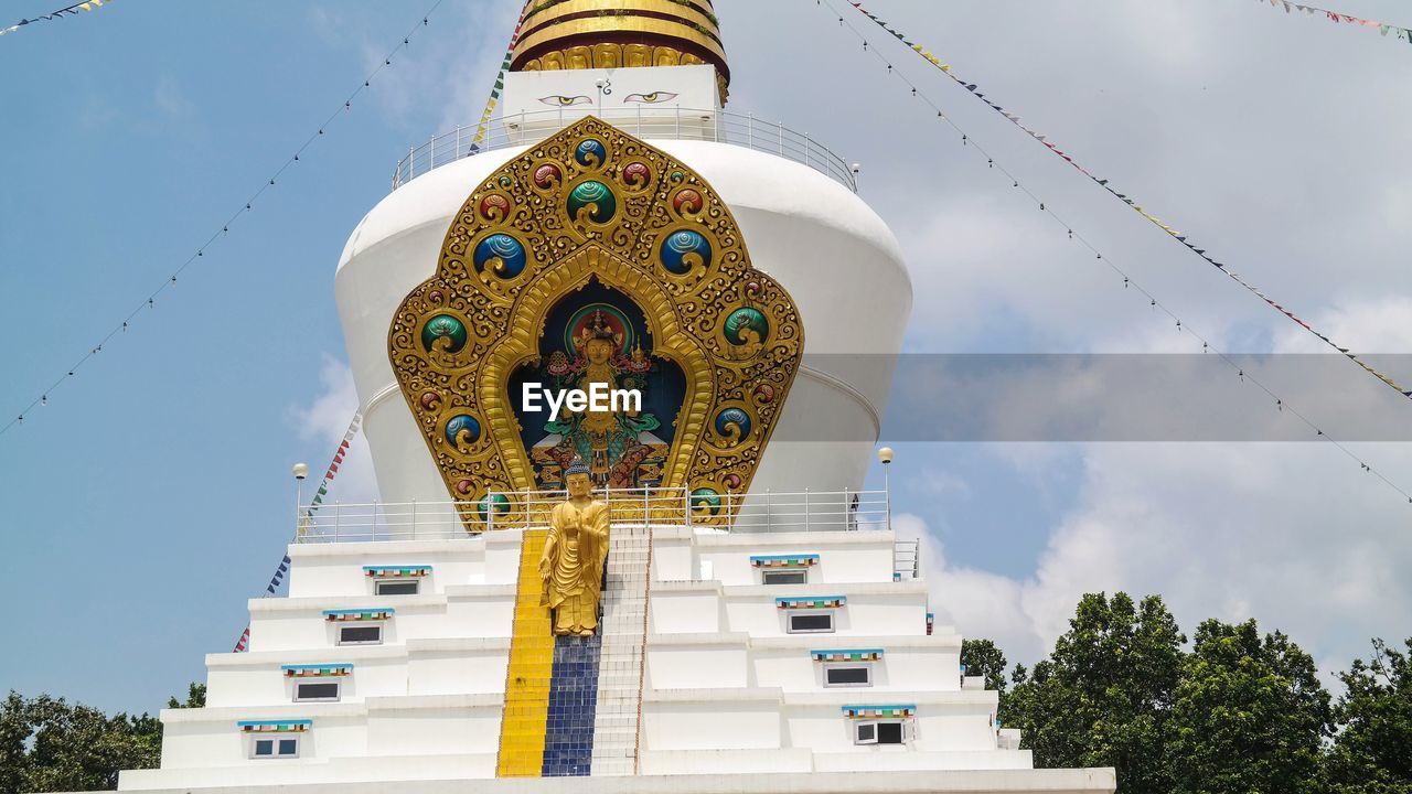 Low angle view of buddhist stupa against sky