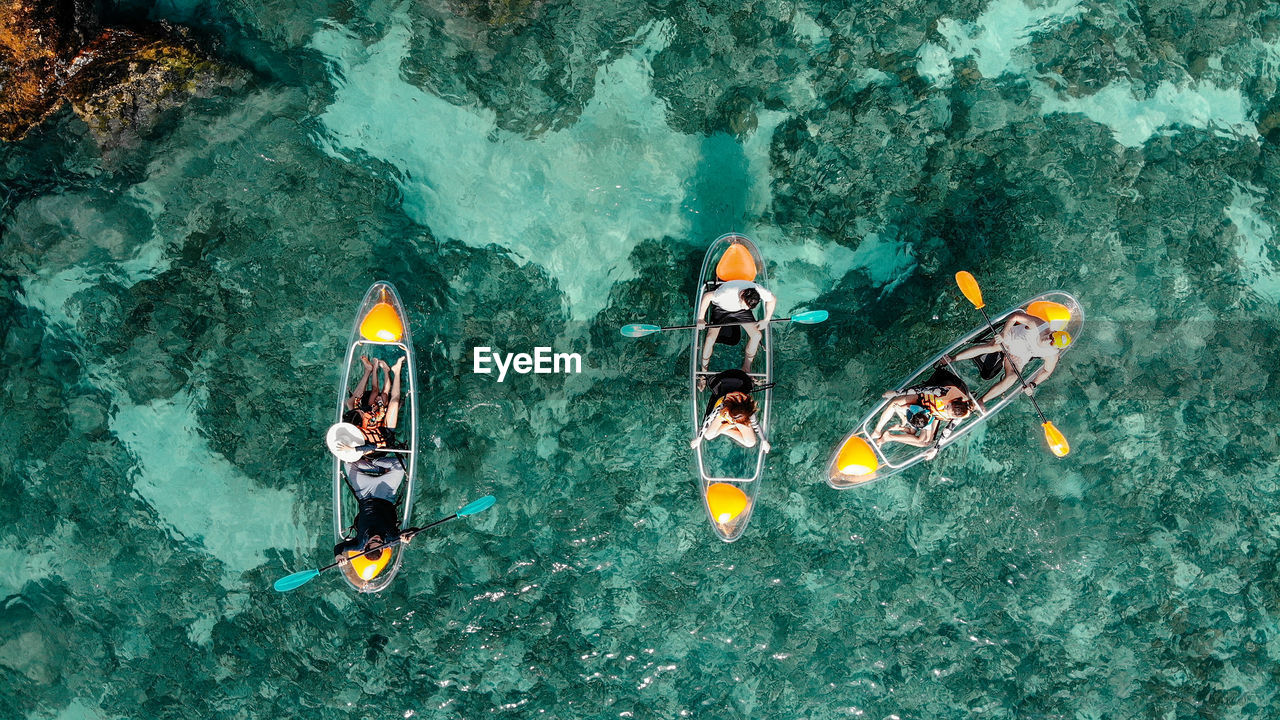 HIGH ANGLE VIEW OF PEOPLE ENJOYING IN SEA